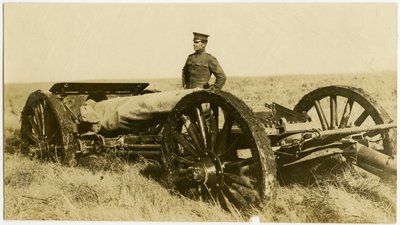 Uniformed Man Standing Next to an Artillery Gun by Carl Michel